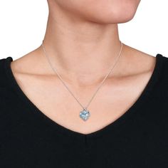 Go the unusual way by proposing her with this classy Sky-Blue Topaz and Diamond Accent Wrapped Stone Heart Pendant with Chain. Crafted in sparkling sterling silver, this dainty pendant showcases a heart-cut, prong-set sky blue topaz gemstone (12x12mm) and 10 round-cut, prong-set diamonds (H-I, I3). Polished to brilliance, this sumptuous pendant is suspended on an 18-inch round cable chain and secured with spring ring clasp. This mesmerizing pendant is certain to make her smile Blue Topaz Necklace With Diamond Accents For Gift, Blue Topaz Necklace With Diamond Accents, Blue Topaz Necklaces With Diamond Accents For Gift, Heart Cut Blue Topaz Jewelry For Gift, Anniversary Blue Topaz Necklace, Heart Cut Blue Topaz Jewelry Gift, Blue Topaz Heart Pendant Necklace As Gift, Blue Topaz Heart Pendant Necklace For Gift, Blue Topaz Gemstone