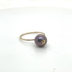 Black Pearl ring  A chubby black freshwater Pearl glows in a blue black hue A tiny gold star magically rests on top of the Pearl for and unusual twist on a classic.  Gold filled ring is polished and dainty. Black Pearl Ring, Black Freshwater Pearls, Solitaire Rings, Gold Filled Ring, Classic Gold, Gold Star, Black Pearl, Gold Stars, Pearl Ring