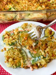 a white plate topped with broccoli casserole next to a red and white checkered table cloth