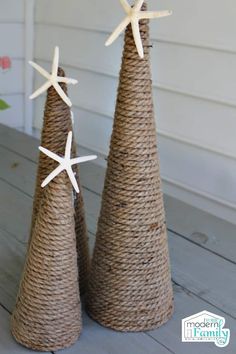 two small christmas trees with starfish decorations on them