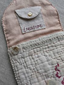 a close up of a small purse with buttons on the front and back of it