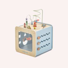 a wooden toy with an animal in it's cage and some beads on the top