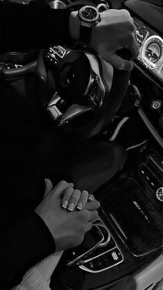 two hands on the steering wheel of a car