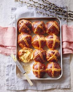 a pan filled with hot cross buns on top of a table