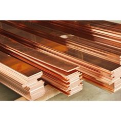 several pieces of copper are stacked on top of each other in an assembly line at a factory