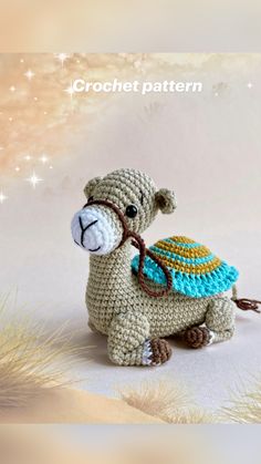 a crocheted camel with a hat on its back