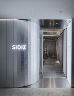 an entrance to a building with the word sidiz on it's wall and door