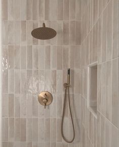 a shower head and hand shower in a bathroom