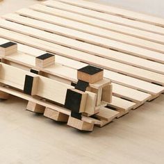 a bed frame made out of wooden planks