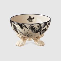 a black and white bowl with flowers on it