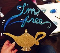 someone is holding up a graduation cap with the words simp free on it and a teapot