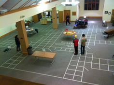 several people are standing in an empty building