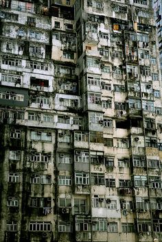 a very tall building with lots of windows and balconies on it's sides