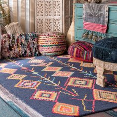 colorful rugs and pillows are arranged on the floor