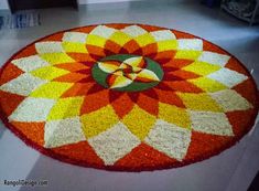 an orange, yellow and red circular rug on the floor