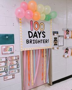 a door decorated with balloons and streamers for a 100th day's brighter