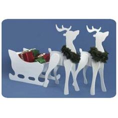 three white reindeer sleighs with christmas presents in the front and on the back