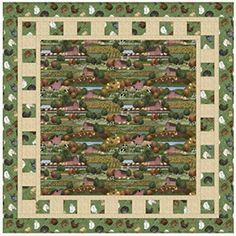 a green and white quilt with farm animals on it's sides, in the middle of