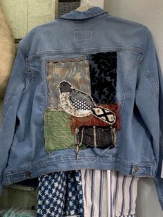 a denim jacket with an image of a bird on it