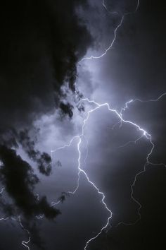 a lightning bolt hitting through the sky with dark clouds