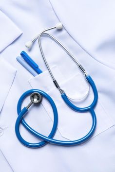 a blue stethoscope laying on top of a white shirt