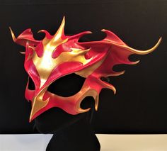 DESCRIPTIONRise from the ashes and transform anew wearing this gorgeous red & gold leather Phoenix Mask. This firebird piece is perfect for Carnivale or Bird CosPlay! Quality leather bird mask, fantastic for Carnivale or Mardi Gras costume. Any color. Waterproofed leather, glossy or matte finish, & several choices to affix the mask (cord, elastic, ribbon, waterproof cord). Measurements: 10" high x 14" wide (tallest & widest points); 10" high between the eyes; 3" wide x 1.5" tall eye Phoenix Mask, Bird Cosplay, Animal Masquerade Mask, Phoenix Costume, Bird Mask, Bird Costume, Bird Masks, Mardi Gras Costumes, Rise From The Ashes