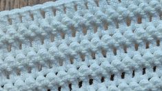 a close up of a white crocheted blanket