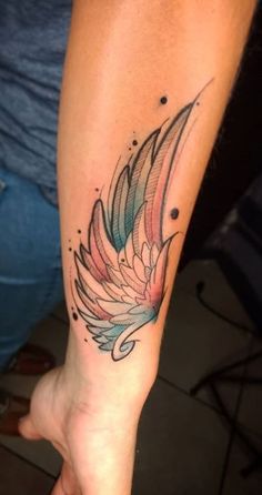 a woman's arm with a bird tattoo on the left side of her arm