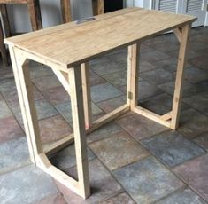 a wooden table sitting on top of a tiled floor