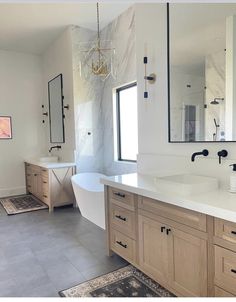 a large bathroom with two sinks and a bathtub