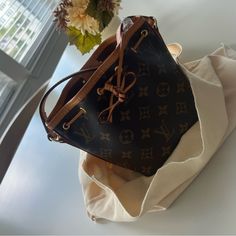 In Great Used Condition! Only Used A Handful Of Times And Is In Mint Condition. No Rips, Tears Or Stains. Strap Is Also In Great Condition And No Cracking To The Leather. Inside Is Nice And Clean And No Dirt Or Stains. Please Feel Free To Ask Any Questions :) Brown Coated Canvas Bag For Everyday Luxury, Everyday Luxury Monogram Canvas Bucket Bag, Chic Everyday Bucket Bag In Monogram Canvas, Chic Monogram Canvas Bucket Bag For Everyday, Luxury Tan Bucket Bag For Shopping, Brown Monogram Canvas Bucket Bag With Adjustable Strap, Brown Monogram Canvas Bucket Bag With Leather Handles, Chic Monogram Canvas Bucket Bag With Leather Handles, Chic Monogram Canvas Bucket Bag For Shopping