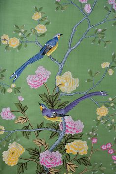 two birds are sitting on a branch with flowers