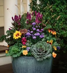 a large pot filled with lots of different types of flowers