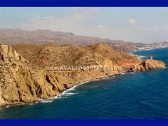 an aerial view of the ocean and rocky coastlines in cabo san lucas, california