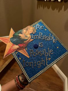 a blue graduation cap with an image of a woman on it and the words, the impossible is possible tonight