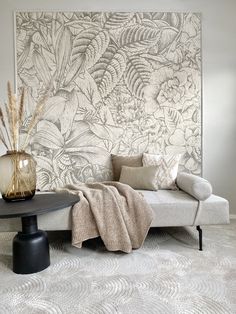 a white couch sitting next to a black table on top of a carpeted floor