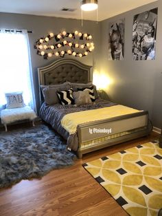 a bedroom with gray walls and yellow accents