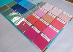 there are many different shades of paint on the table top, including pink and blue