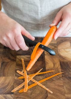 a person cutting up carrots with a knife