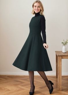 ★★ Welcome to my Ylistyle's shop！！！ The dress features a flattering silhouette with a fitted bodice and a gently flared skirt that falls gracefully to mid-calf length. It has long sleeves and a high round neckline, making it suitable for both formal and casual occasions.  ★★FEATURES * 30% wool, 30% fiber, 40% polyester * Polyester lining * Sleeveless dress * Two side seam pockets * Round neck * Back zipper closure * High waistband * Fit and flare * Perfect for winter, autumn, spring * Dry clean ★★ The model's height approx 170 cm (5′ 7″) with the 84 cm (33") bust, 66 cm (26") waist. She is wearing the wool dress in size XS (US2) ★★ Please select custom order according to the follow situation Can't find your size Your height is over 175cm Your weight is over 75kg Request Length custom Reque Dark Green Fit And Flare Dress, Fitted A-line Vintage Dress For Winter, Green Sleeveless Dress For Fall, Green A-line Winter Dress, Elegant Sleeveless Winter Midi Dress, Fitted Sleeveless Dress For Fall, Green Fit And Flare A-line Sleeveless Dress, Green A-line Midi Dress For Winter, Fitted Knee-length Vintage Dress For Winter