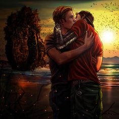 two people embracing each other in front of the ocean and birds flying overhead at sunset