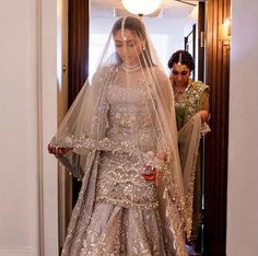 the bride is getting ready to walk down the aisle in her wedding dress and veil