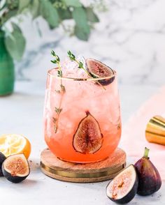 a glass filled with ice and sliced figs