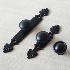 black handles and knobs on a white surface