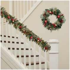 a christmas garland on the banister next to stairs