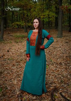 Dress made of 100% woolen diamond in turquoise and grey colour, decorated with persian lions silk damask, red silk and real pearls.  Dress is available in two options :  1. Dress in stock - dress as pictured in photos, fits to this measurements :  Chest : 100 -106 in circumference Hips : 98 - 112 in circumference Arm length from neck to wrist : 68 - 72 cm  Biceps part of the arm : 28 - 32 Length : 152 cm (from the tip of the shoulder to the bottom) Dress can be shortened ! Also this dress would Rus Viking, Pearls Dress, Kievan Rus, Woolen Dress, Viking Dress, Invisible Stitch, Woolen Dresses, Pearl Decorations, Dupioni Silk