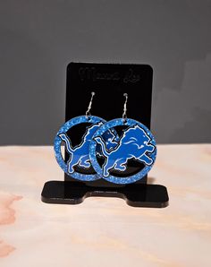 PLEASE READ *Set a statement with these Lions Earrings.  *Silver earring finish *The back is wood & front is sublimated image *Earring size is 3 inches long and or wide.  * Please check the model photo to ensure the earrings is a great size for you * Thank you for purchasing Lion Earrings, Football Earrings, Thank You For Purchasing, Detroit Lions, Silver Earring, Model Photos, Earrings Silver, Jewelry Earrings Dangle, Silver Earrings