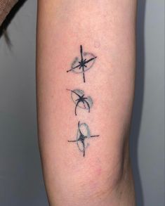 a cross tattoo on the right thigh