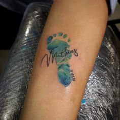 a person with a tattoo on their arm that says matria's and is next to a foot print