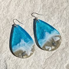 These realistic beach earrings are made with layers of shimmering translucent resin, real sand and bright colorful inks with a silver plated sea turtle. They are available in 2 sizes. These are made to order and yours may be slightly different than those pictured. Silver Teardrop Earrings For Beach, Resin Earrings For Summer Beach, Summer Beach Resin Earrings, White Resin Earrings For The Beach, Resin Dangle Earrings For Beach, Summer Beach Teardrop Earrings, Beach Dangle Teardrop Earrings With Ear Wire, Multicolor Teardrop Jewelry For Beach, Blue Resin Earrings For Beach